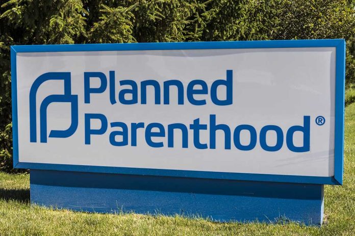 Planned Parenthood sign on a grassy lawn.