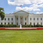 White House with fountain and American flag visible