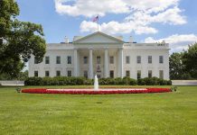 White House with fountain and American flag visible