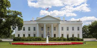 White House with fountain and American flag visible