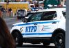 NYPD police car on a city street scene.