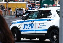 NYPD police car on a city street scene.