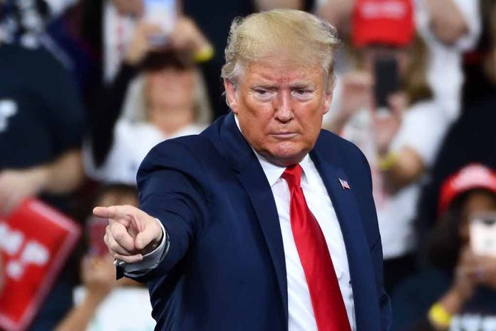 Man in suit pointing at rally audience