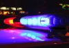 Police car lights flashing red and blue.
