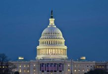 U.S. Capitol building illuminated at dusk.