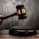 Judge's gavel hitting a sound block