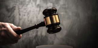 Judge's gavel hitting a sound block