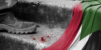 A boot next to blood and the Palestinian flag