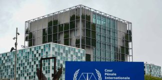 International Criminal Court building with sign in foreground.