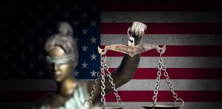 Blindfolded Lady Justice in front of American flag