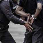 Man arrested and handcuffed