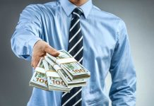 Person handing over a stack of money