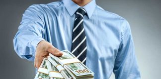 Person handing over a stack of money