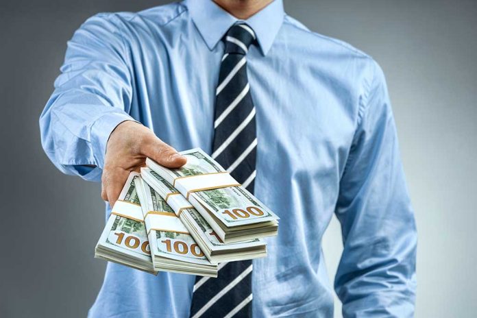 1008204853 featured image Person handing over a stack of money