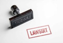 Rubber stamp with lawsuit text on paper