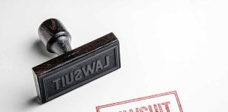 Rubber stamp with lawsuit text on paper