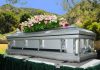 Silver casket with flowers at outdoor funeral
