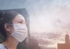Person wearing a mask in a cityscape background