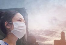 Person wearing a mask in a cityscape background