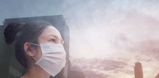 Person wearing a mask in a cityscape background