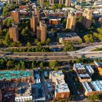 Aerial view of urban area with tall buildings and freeway