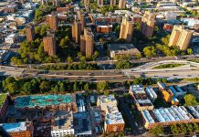 Aerial view of urban area with tall buildings and freeway