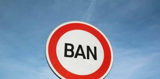 Sign with word BAN against clear sky