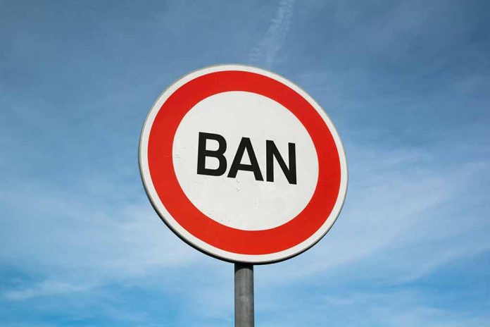 Sign with word BAN against clear sky