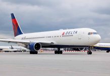 Delta Airlines airplane on airport runway cloudy sky