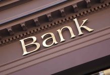 Gold bank sign on building facade