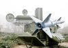 Military missile launcher with radar systems in a foggy field