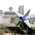 Military missile launcher with radar systems in a foggy field