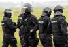 Police officers in tactical gear standing together outdoors