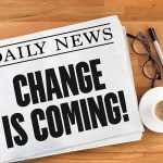 Newspaper headline Change Is Coming on table
