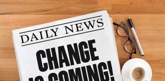 Newspaper headline Change Is Coming on table