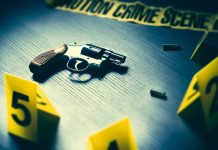 Revolver and evidence markers at crime scene table