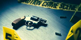 Revolver and evidence markers at crime scene table