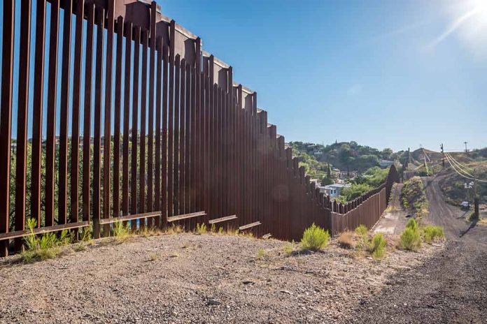 657897121 featured image Tall metal border fence in desert landscape sunlight