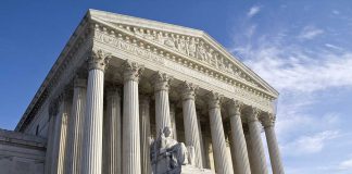 Supreme Court building with columns and statue in front