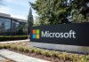 Microsoft sign with office buildings and trees.