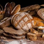 Assorted breads with seeds and baking ingredients
