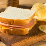 Ham and cheese sandwich with potato chips