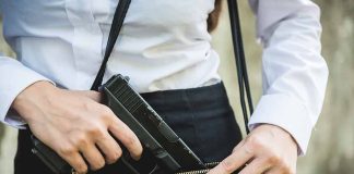 Person placing gun into a handbag