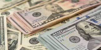Stacks of various US dollar bills
