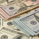 Stacks of various US dollar bills