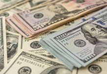Stacks of various US dollar bills