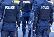 Police officers in riot gear with shields