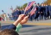Hands holding flags at a parade event