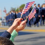 Hands holding flags at a parade event