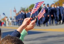 Hands holding flags at a parade event